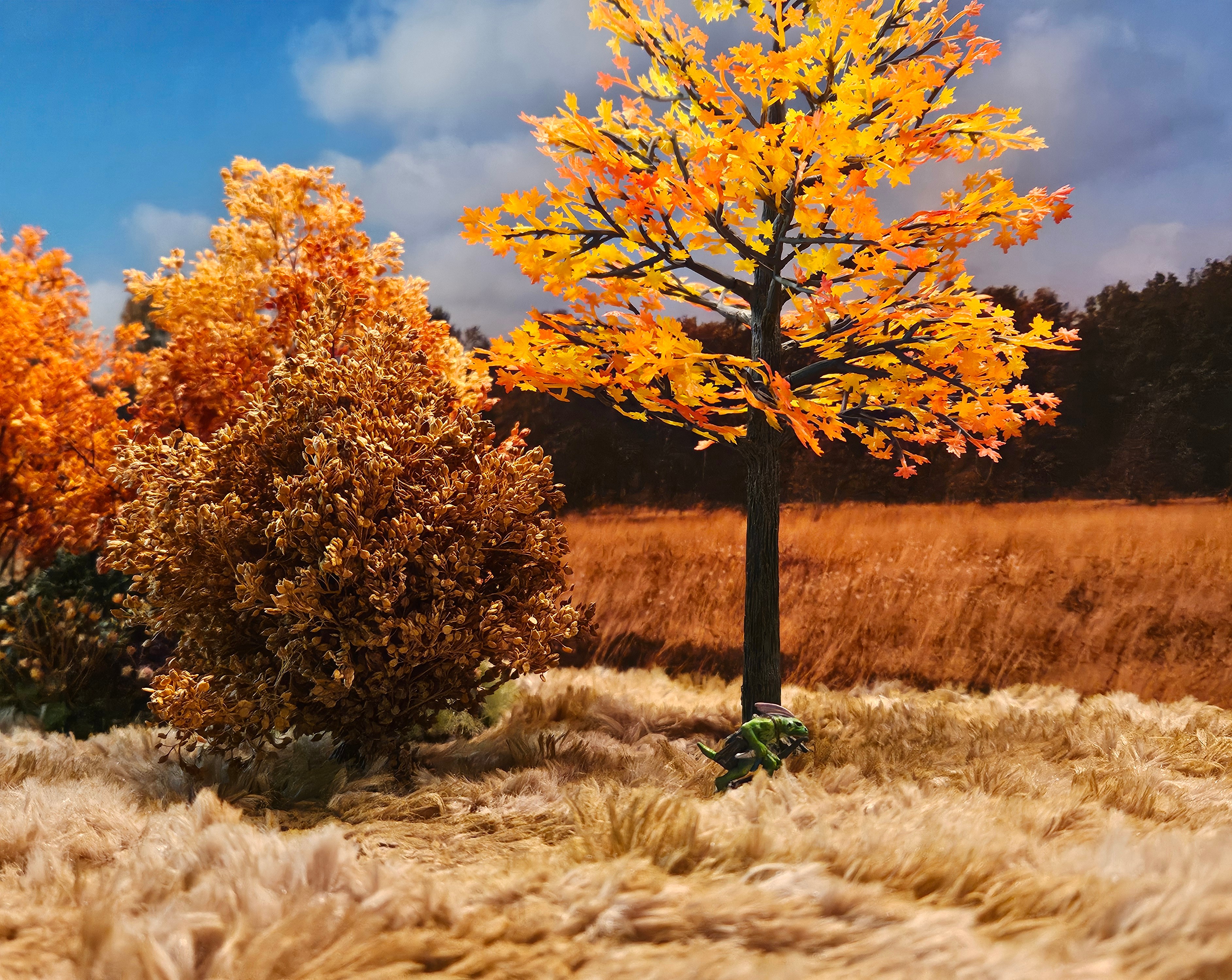 Photo of a lizard model in tall grass and fall colors